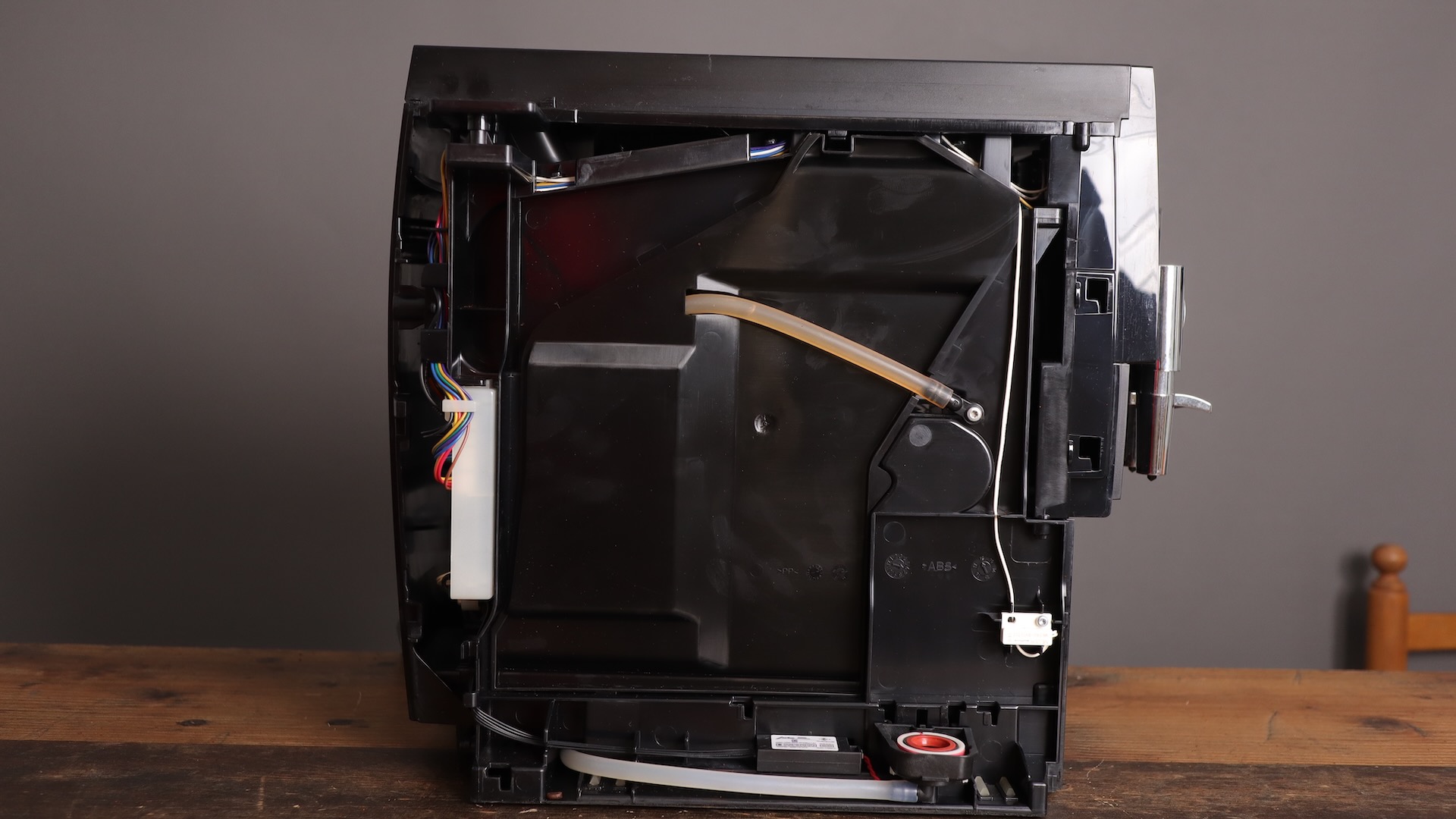 Left side of the Jura E8 espresso machine exposed, showing water path